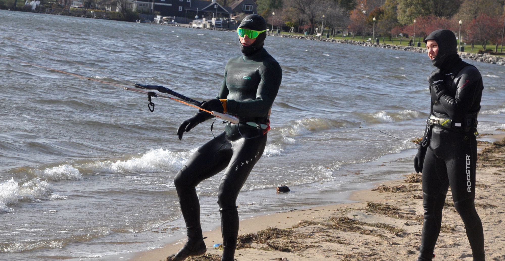 Charlie Vogel, left, and Harry Melges pull in a giant kite from Geneva Lake, as the end a round of kite boarding